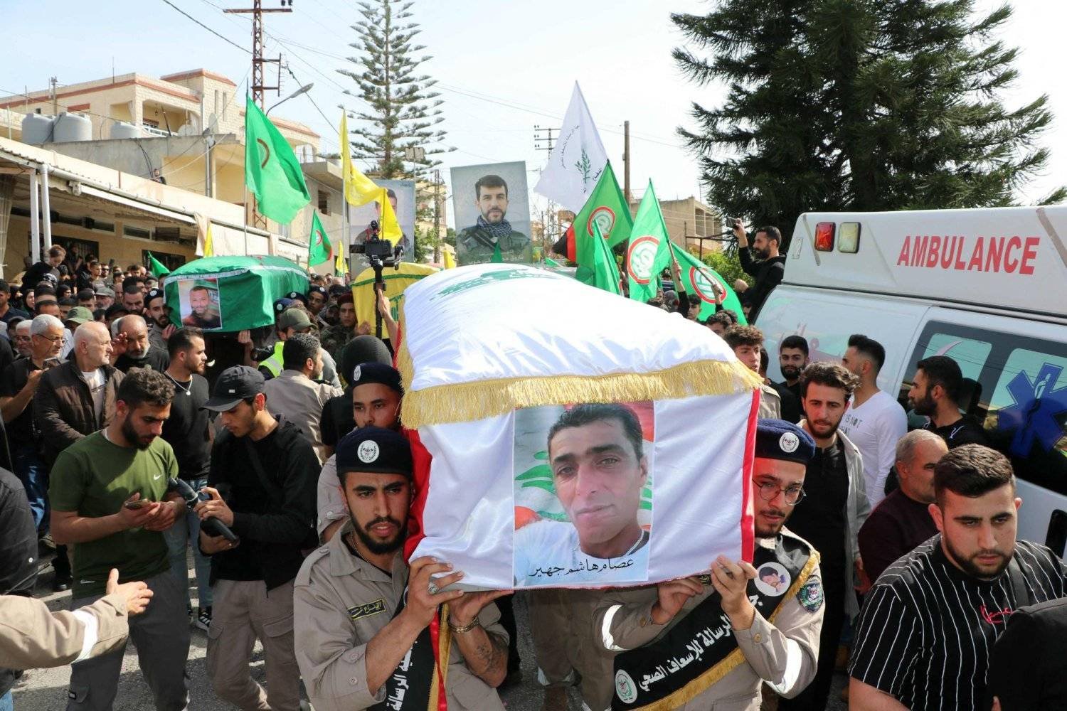 Mourners carry the flag-draped caskets of four people killed in an overnight Israeli strike in the southern Lebanese border village of Naqoura, during their funeral procession on March 28, 2024. (Photo by AFP)