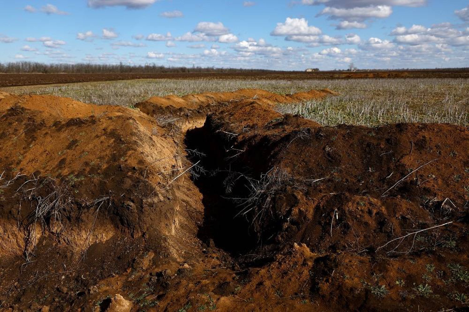 A trench is seen in the field of grain farmer Oleksandr Klepach, amid Russia's invasion of Ukraine, in Snihurivka, southeast Ukraine, February 20, 2023. (Reuters)