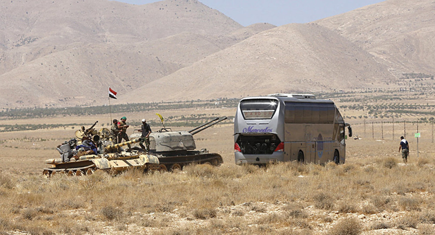 A bus convoy with ISIS terrorists militants heads to Syria from Lebanon amid a withdrawal deal with the army. (AFP)
