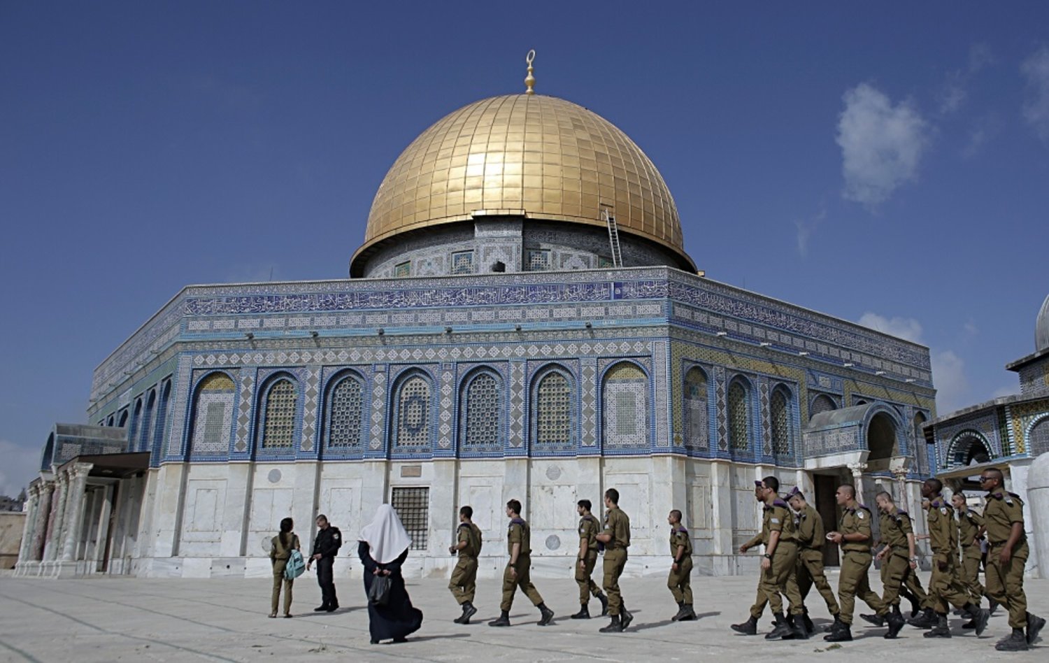 Israeli soldiers walk past the Dome of the Rock in the Al-Aqsa mosque compound. (AFP)