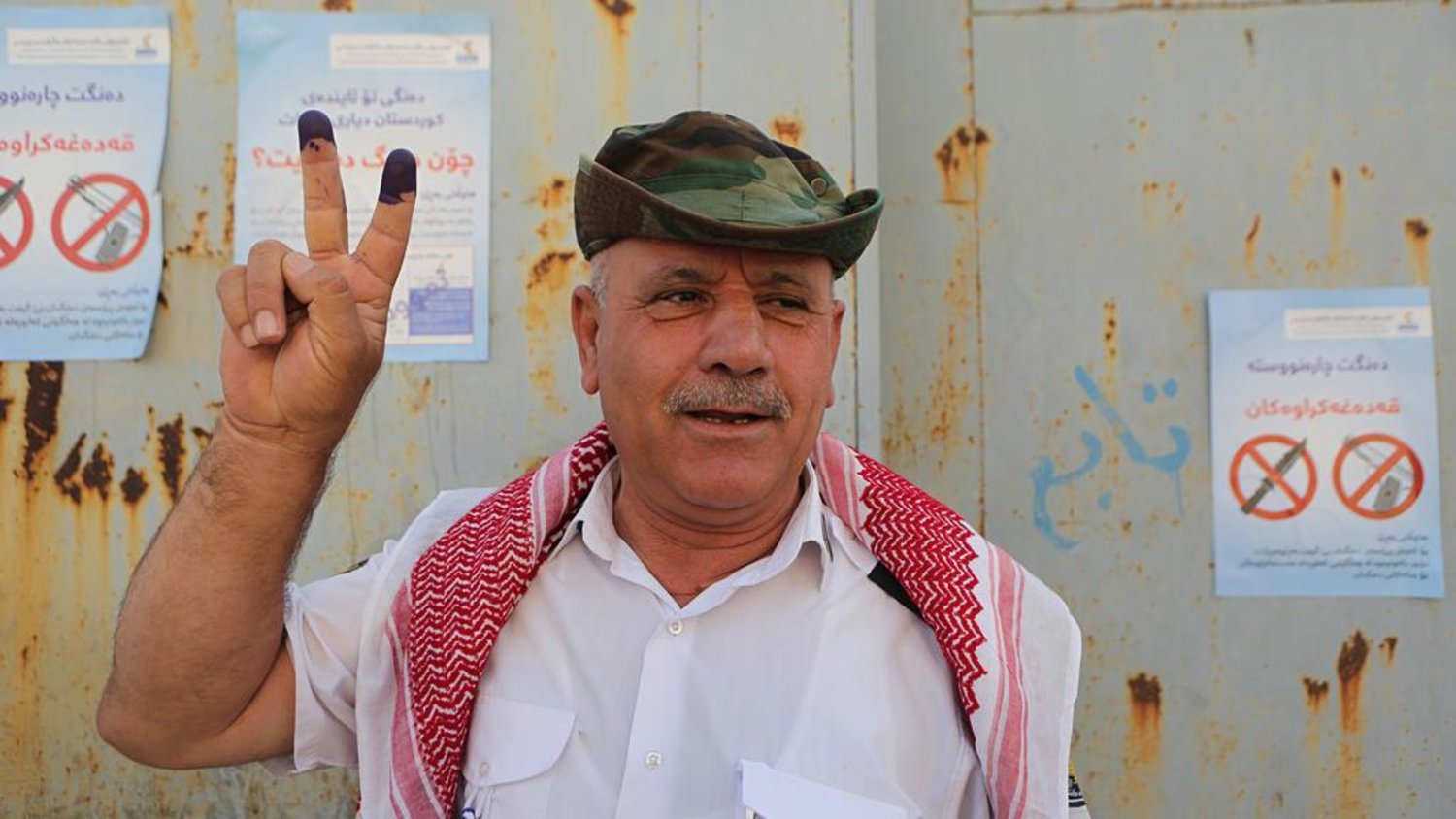  An Iraqi Kurdish man poses with his inked fingers after casting a vote during the referendum on independence from Iraq in Irbil on September 25, 2017. Khalid Mohammed / AP