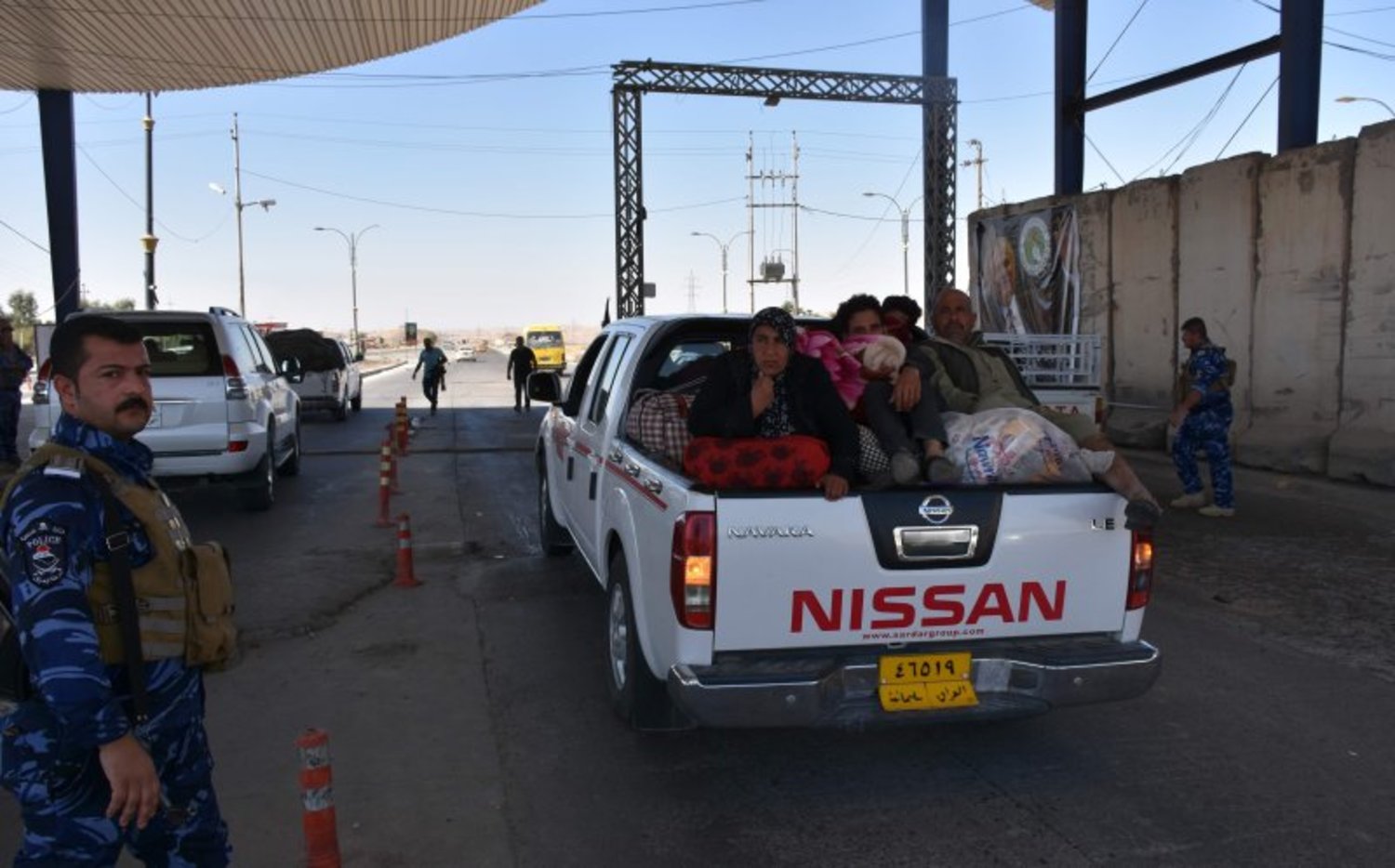 Kurdish families pass through a checkpoint as they return to Kirkuk last Tuesday. Photo: Marwan Ibrahim/AFP