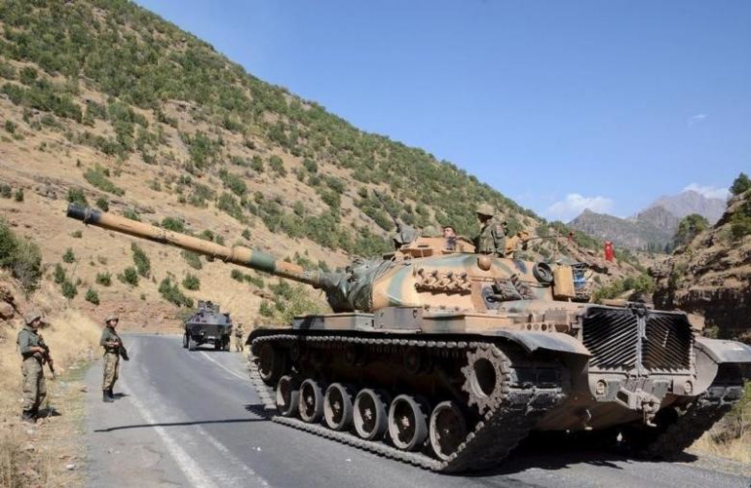 Turkish soldiers in a tank and an armored vehicle patrol on the road to the town of Beytussebab in the southeastern Sirnak province, Turkey, September 28, 2015. REUTERS/Stringer