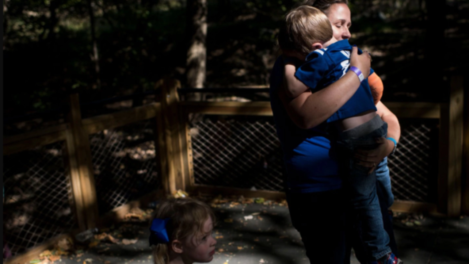 Alyssa, 3, walks by her mother, Julie Schlomer, as she comforts her twin brother, Logan, after he became upset about going down a slide at the Maryland Zoo in Baltimore during a special families event hosted by Shady Grove Fertility, the Rockville clinic that helped Schlomer have the children via a shared egg donor and in vitro fertilization. (Carolyn Van Houten/The Washington Post) 