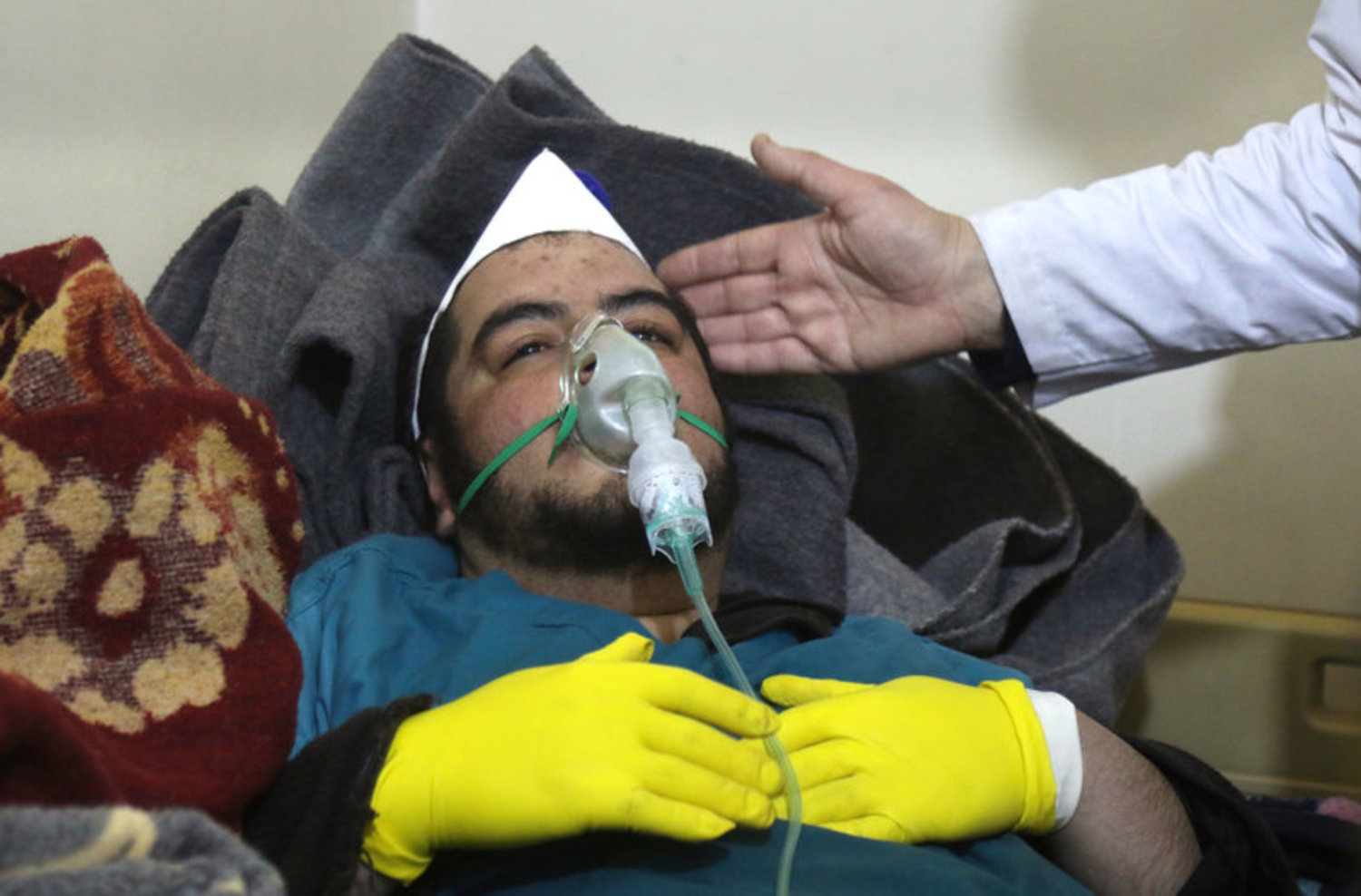 A Syrian man receives treatment following a suspected toxic chemical attack Tuesday in Khan Shaykhun, a rebel-held town in Syria's northwestern Idlib province. At least 72 people were killed, including a number of children. Mohamed al-Bakour/AFP
