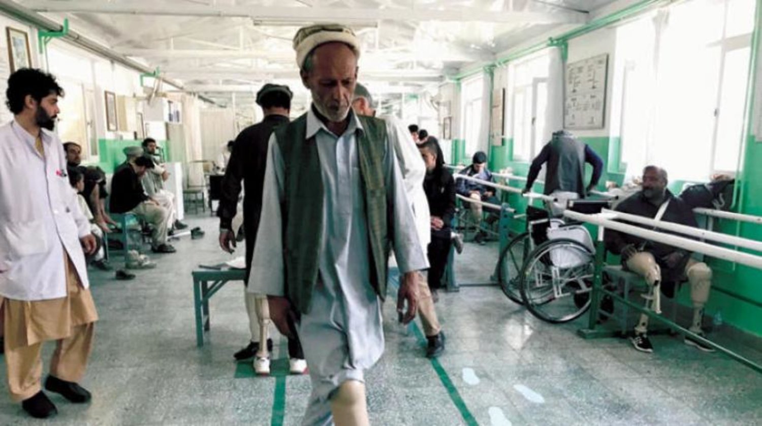 An Afghan man who lost his leg to a landmine tries out his new prosthetic leg inside a Red Cross orthopedic center in Kabul. (Antonio Olivo/The Washington Post)