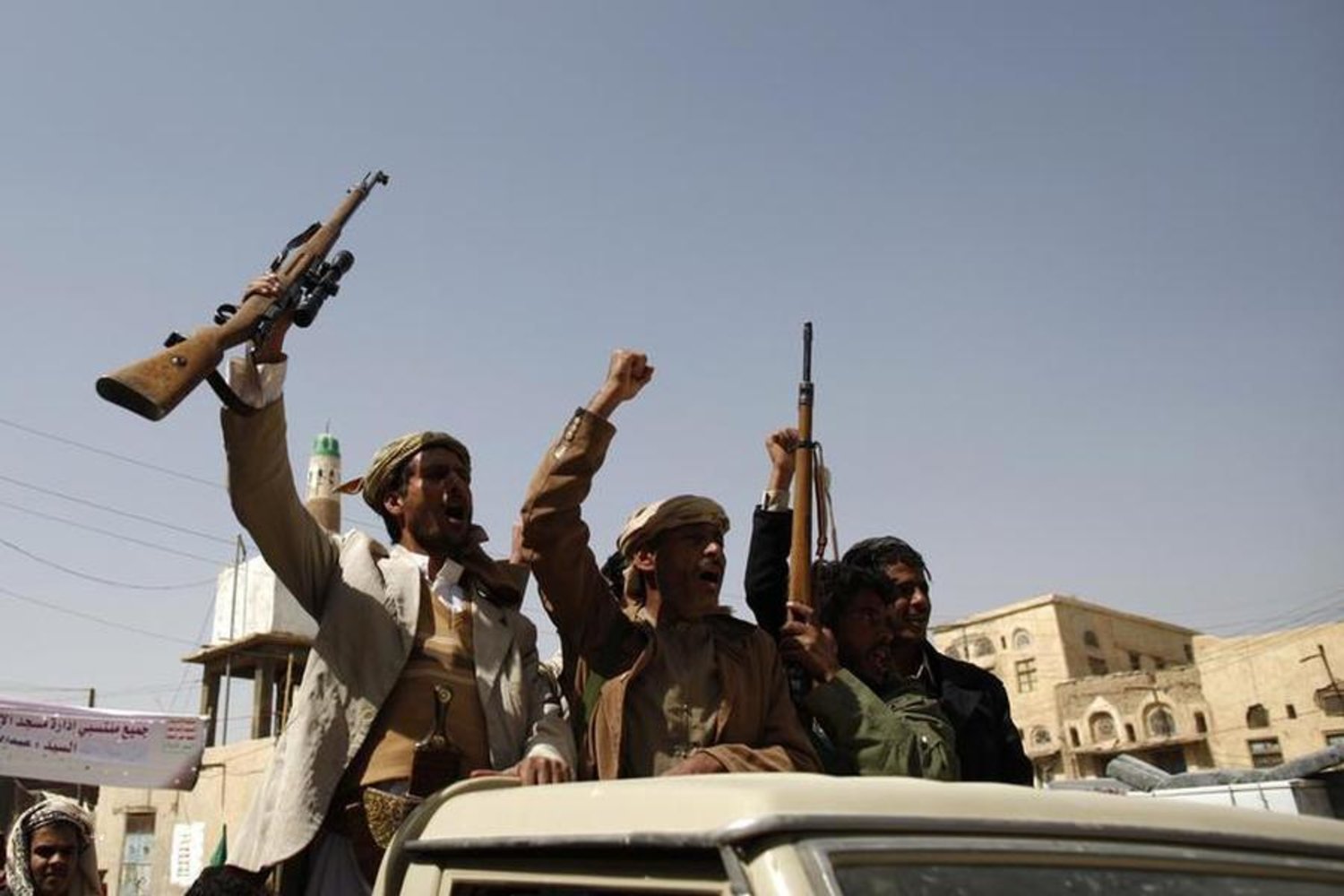 Houthi militants shout slogans as they ride a pick-up truck in the northwestern Yemeni city of Saada. Reuters