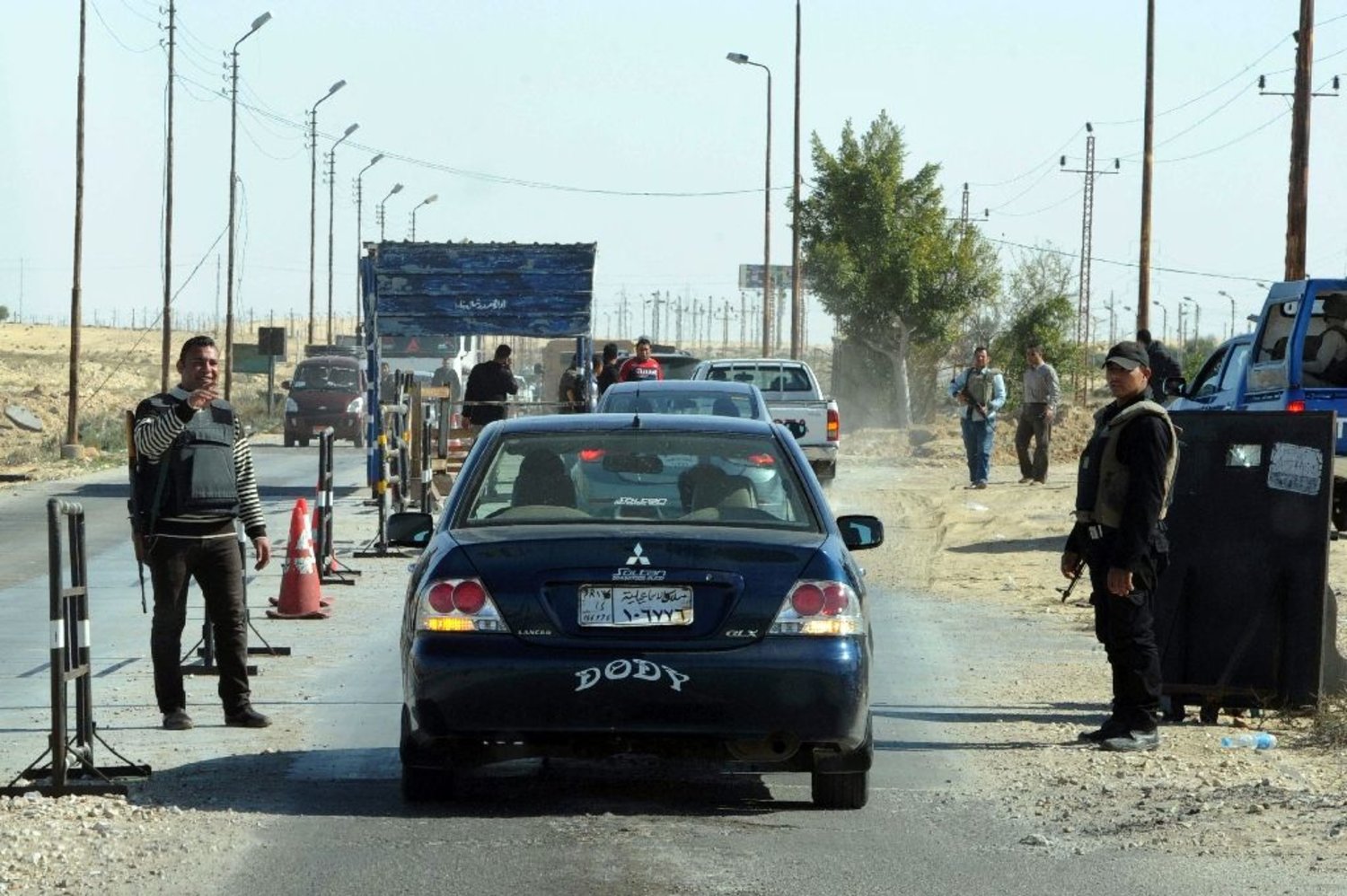 Egyptian police inspect cars at a checkpoint in North Sinai. (AFP)