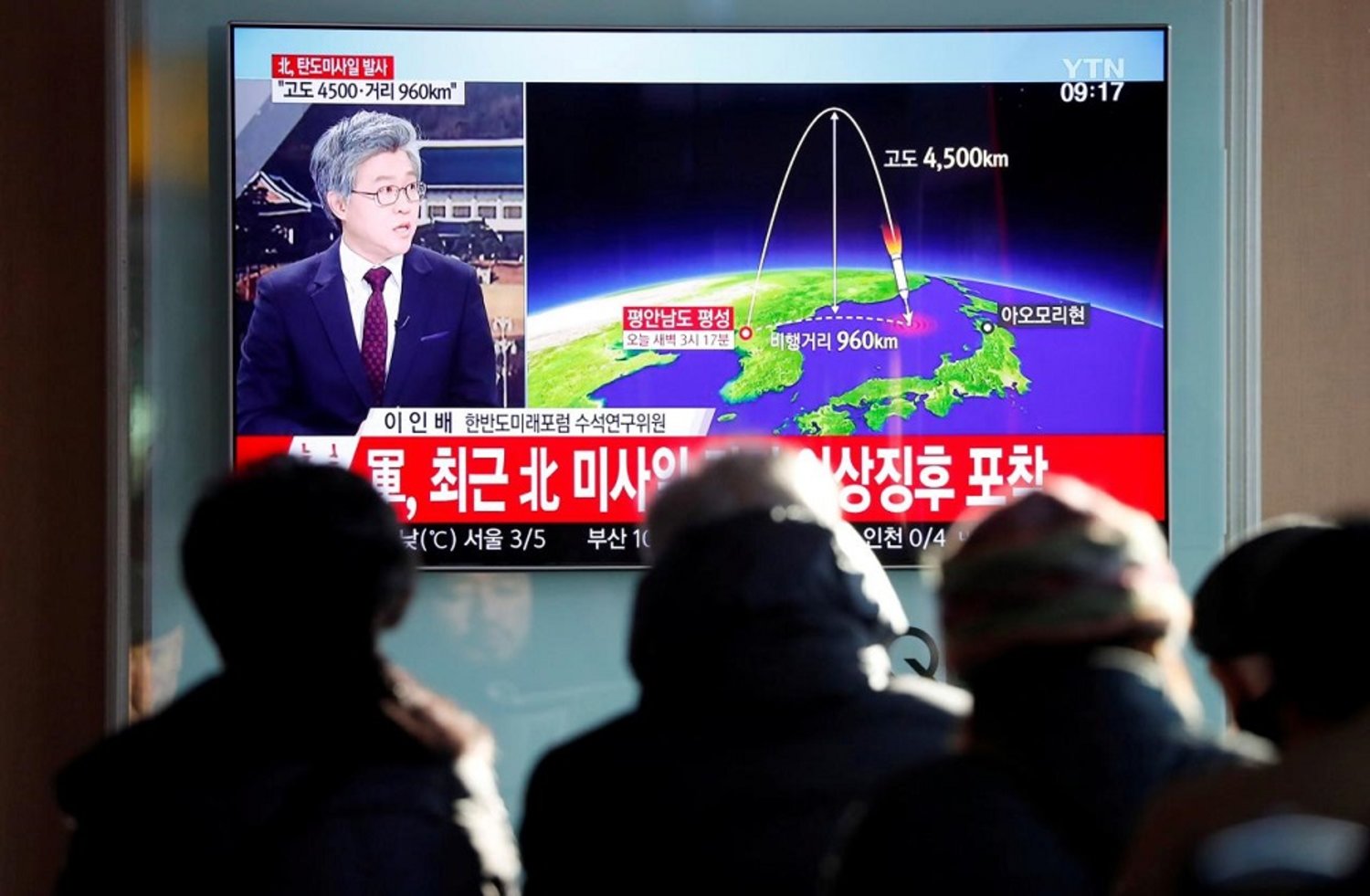 People watch a television broadcast of a news report on North Korea firing what appeared to be an intercontinental ballistic missile that landed close to Japan, in Seoul, South Korea. (Reuters)