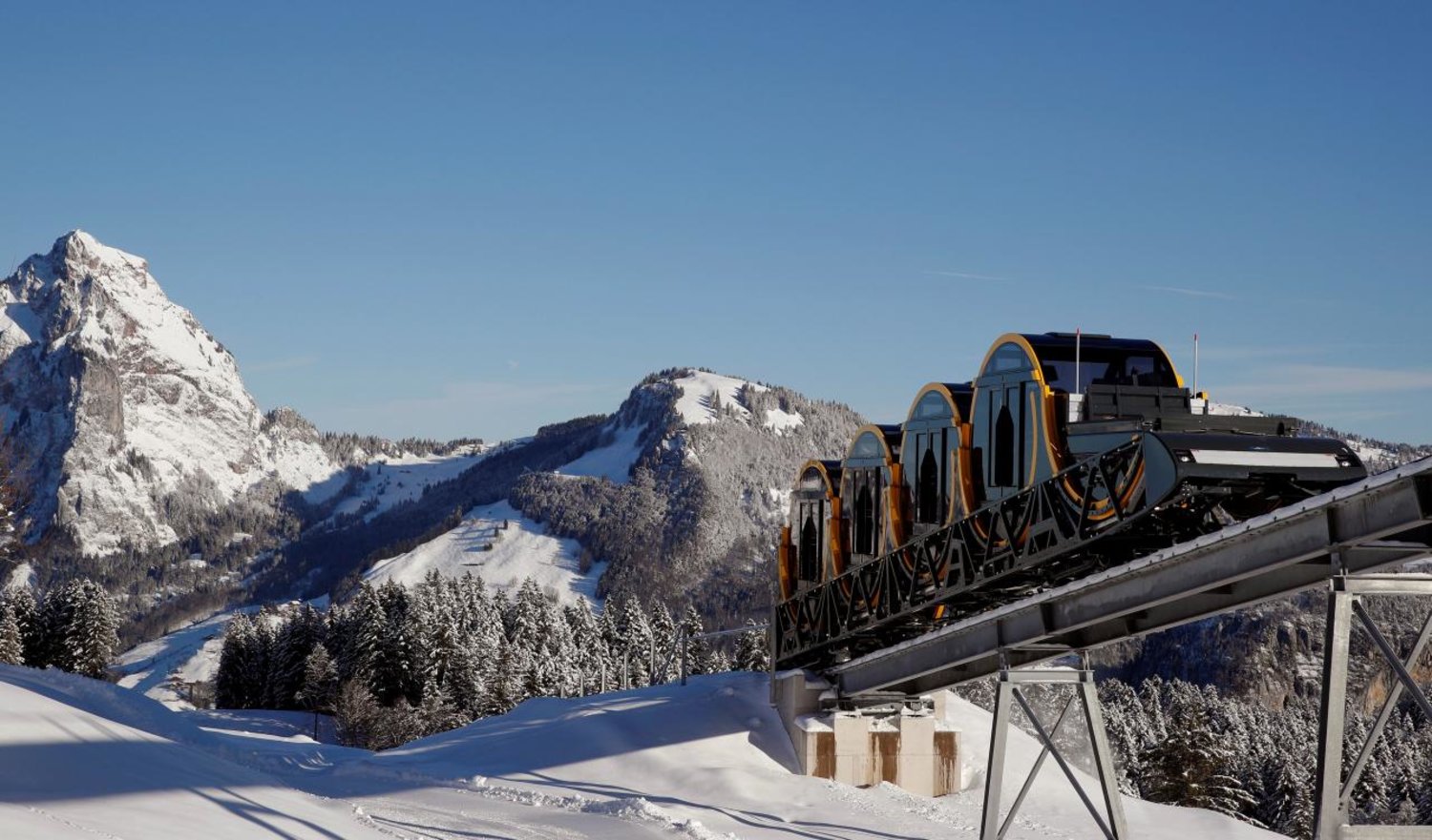 The barrel-shaped carriages of a new funicular line are seen front of mount Grosser Mythen (1,898 m/6,227 ft above sea level) during sunny winter weather in the Alpine resort of Stoos, Switzerland December 13, 2017. Picture taken on December 13, 2017. REUTERS/Arnd Wiegmann