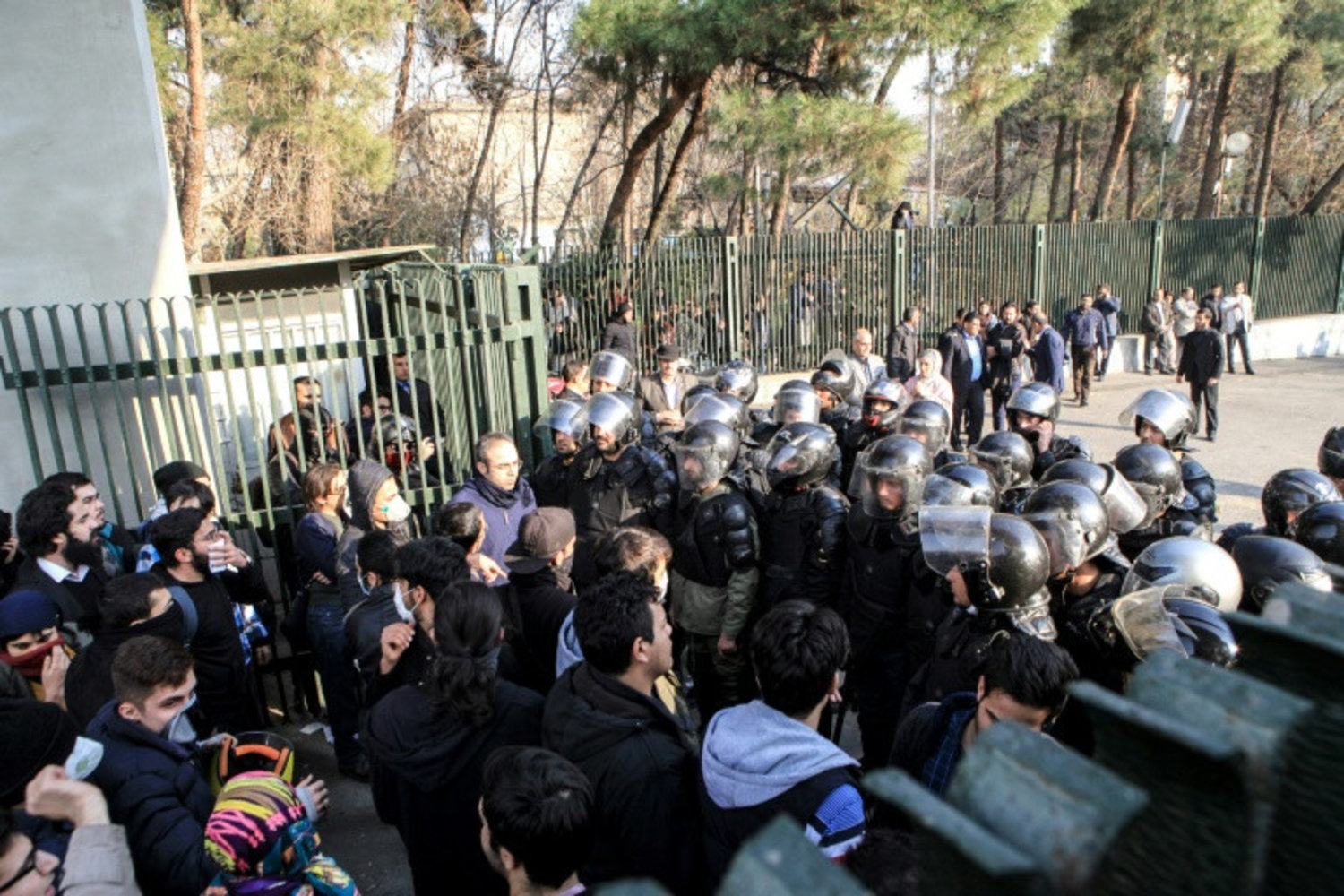 Students scuffle with police at the University of Tehran during a demonstration driven by anger over economic problems in the Iranian capital Tehran on December 30, 2017. (AP)