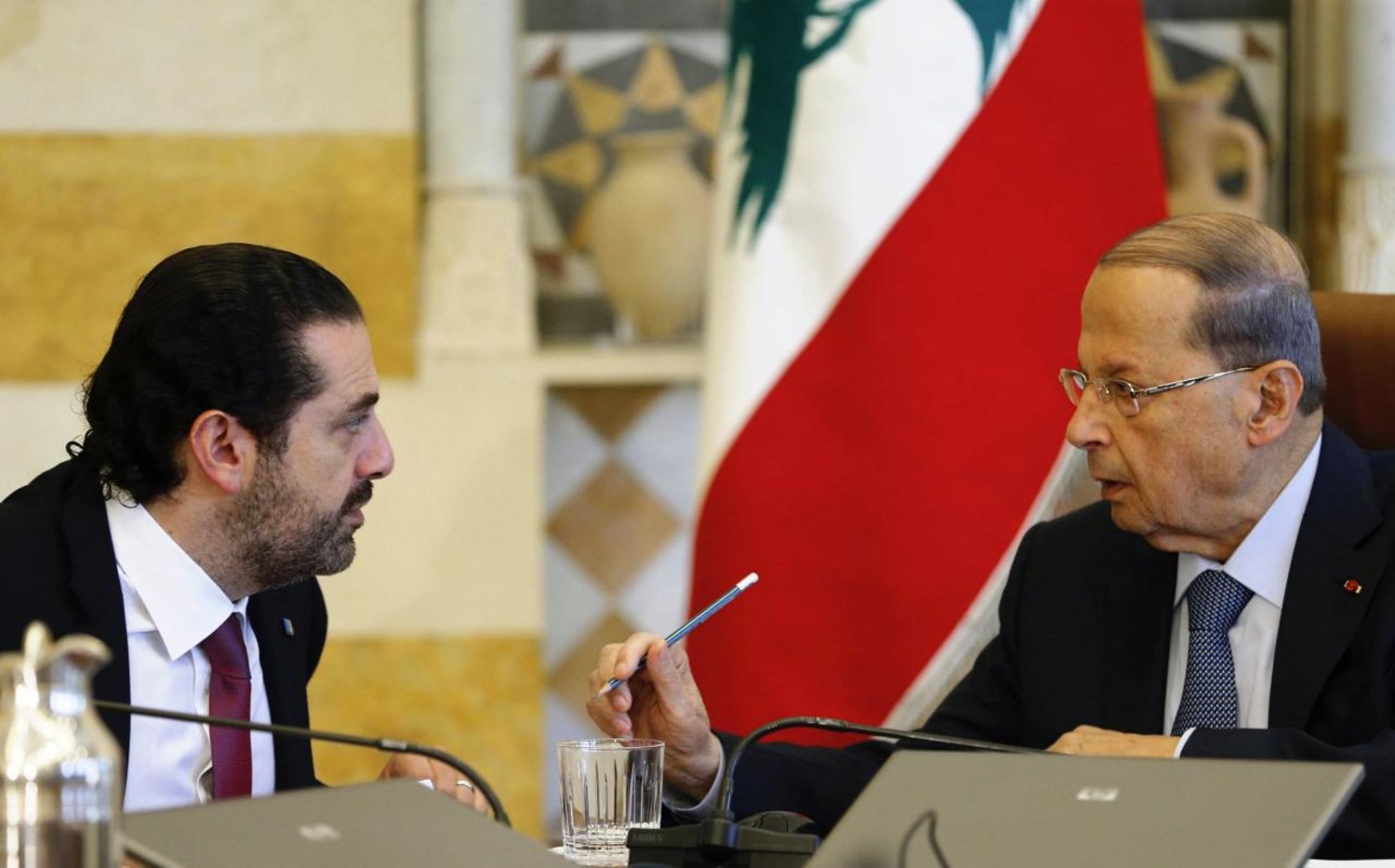 Lebanon’s President Michel Aoun talks to Prime Minister Saad al-Hariri during the cabinet meeting in Baabda near Beirut, Lebanon December 5, 2017. REUTERS/Mohamed Azakir