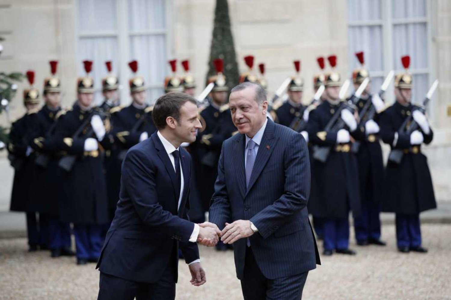 Turkish President Recep Tayyip Erdogan, right, is welcomed by French President Emmanuel Macron, at the Elysee Palace in Paris. (AP)