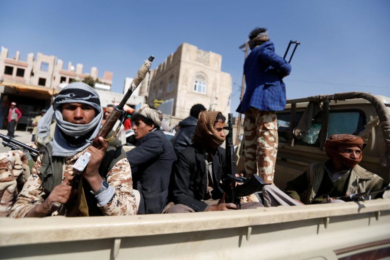 Houthi militants ride on the back of a truck in Sana'a. Reuters