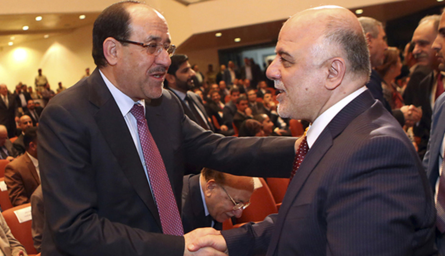 Iraq's Vice President Nouri al-Maliki (L) and new Prime Minister Haider al-Abadi shake hands during the session to approve the new government in Baghdad, Sept. 8, 2014. (crédit photo:  REUTERS/Hadi Mizban)
