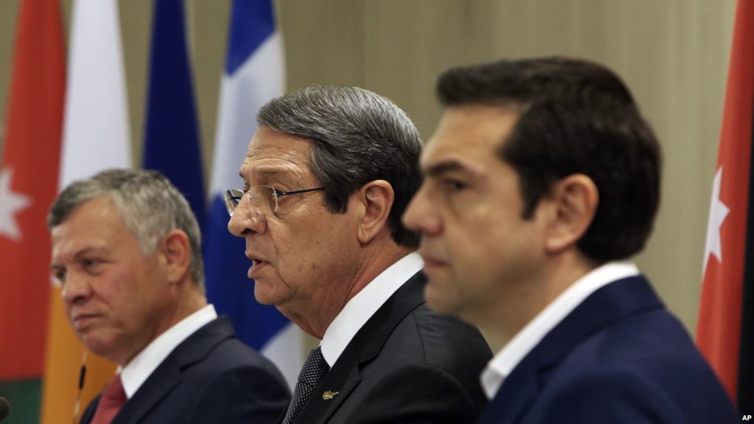 Cyprus President Nicos Anastasiades, center, talks to the media as Jordan's King Abdullah II, left, and Greek Prime Minister Alexis Tsipras listen during a press conference at the Presidential palace in capital Nicosia, Cyprus, on Tuesday. Jan. 16, 2018. (AP) 