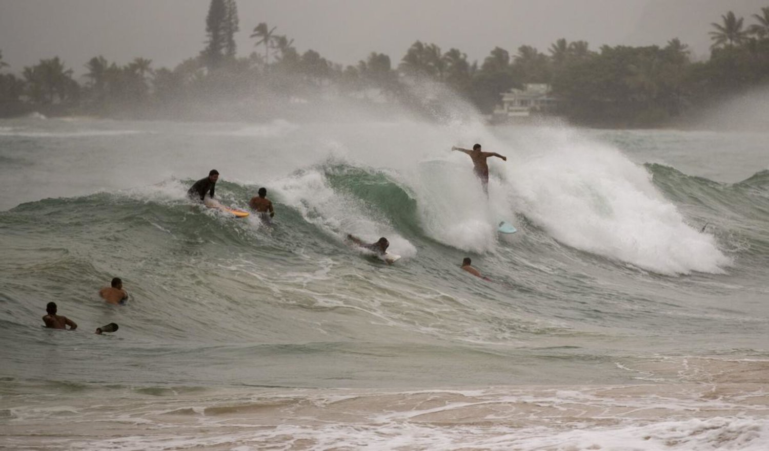 Surfers take on large waves generated by Hurricane Douglas at Laie Beach Park, Sunday, July 26, 2020, in Laie, Hawaii. (AP Photo/Eugene Tanner)