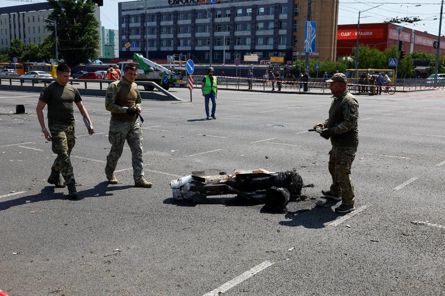 Police officers walk next to a part of a missile which landed on a street during a Russian strike, amid Russia's attack on Ukraine, in Kyiv, Ukraine May 29, 2023. (Reuters) 
