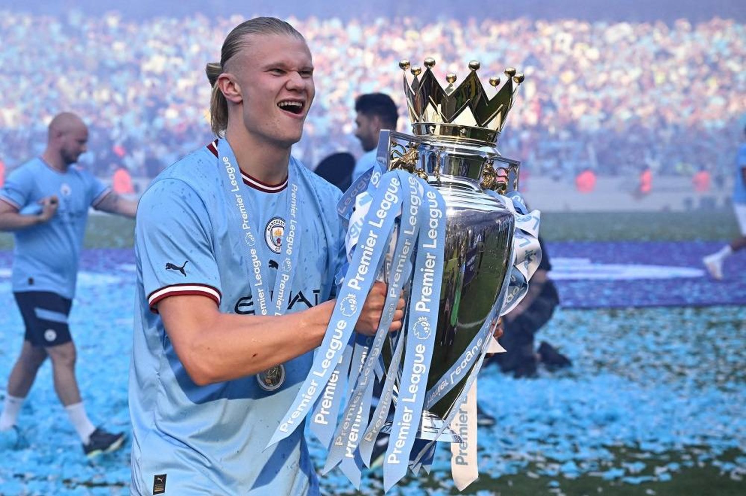 Manchester City's Norwegian striker Erling Haaland poses with the Premier League trophy on the pitch after the presentation following the English Premier League football match between Manchester City and Chelsea at the Etihad Stadium in Manchester, northwest England, on May 21, 2023.(AFP) 