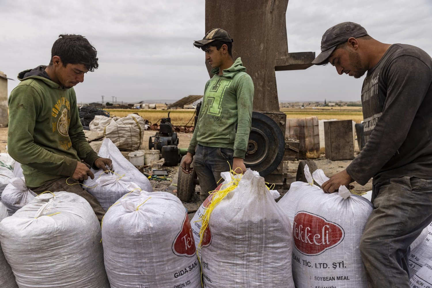 30 May 2023, Syria, Idlib: Workers seal sacks of plastic items collected from landfills, before transfering them to be crushed and recycled into usable products. Photo: Anas Alkharboutli/dpa