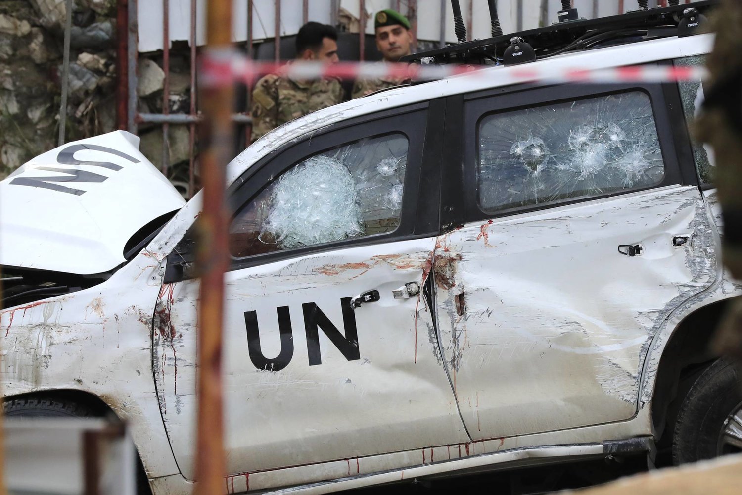 FILE - Lebanese soldiers stand behind a damaged vehicle after a UN peacekeepers convoy came under fire in the Al-Aqbiya village, south Lebanon, Thursday, Dec. 15, 2022. (AP Photo/Mohammed Zaatari, File)