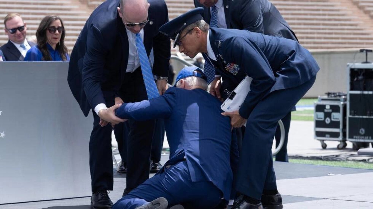 US President Joe Biden is helped up after falling during the graduation ceremony at the United States Air Force Academy. Brendan Smialowski / AFP
