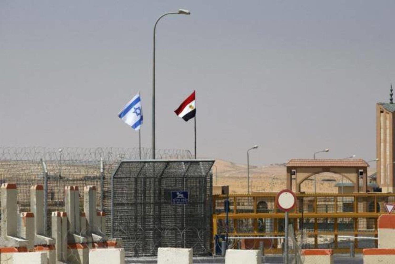 The Israeli and Egyptian flags are seen at a border crossing, (Reuters file photo) 