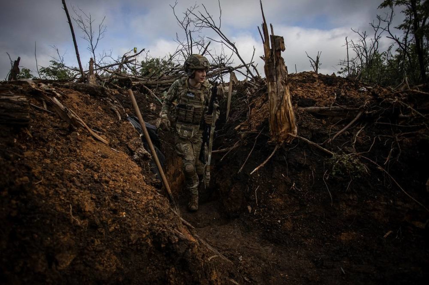 A Ukrainian serviceman walks in a trench at a position near the frontline town of Bakhmut, amid Russia's attack on Ukraine, in Donetsk region, Ukraine May 30, 2023. (Reuters) 