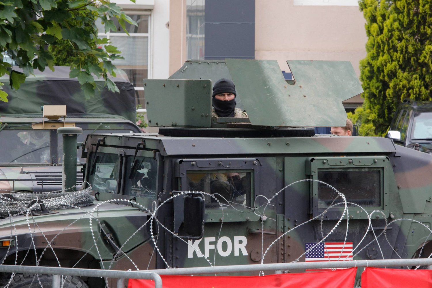 A US member of the NATO-led Kosovo Force (KFOR) stands guard in an armored vehicle outside municipal offices in Leposavic, Kosovo, June 2, 2023. REUTERS/Ognen Teofilovski/File Photo
