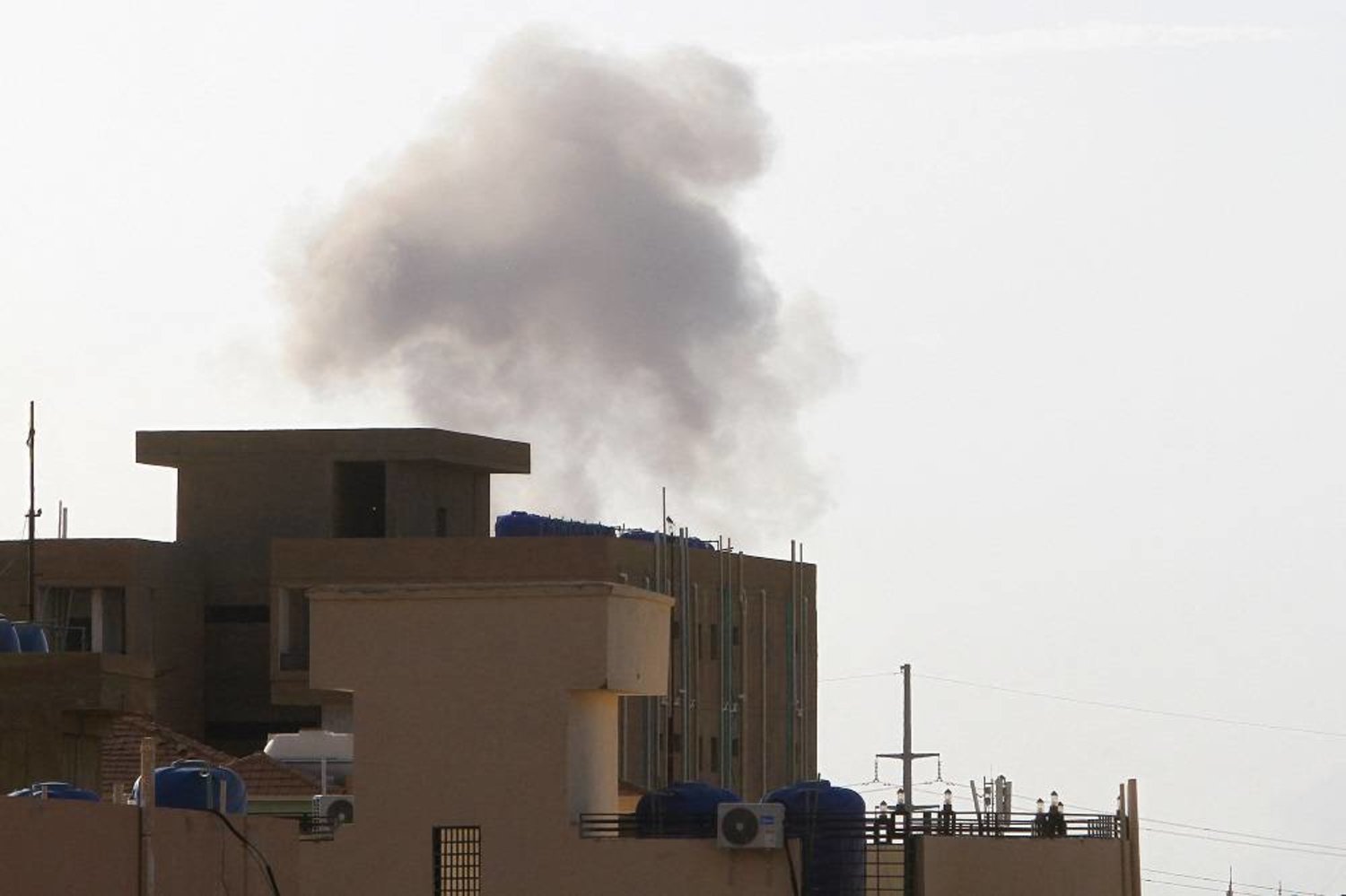 Smoke billows behind buildings in Khartoum on June 2, 2023, as fighting between Sudan's warring generals intensified. (AFP) 
