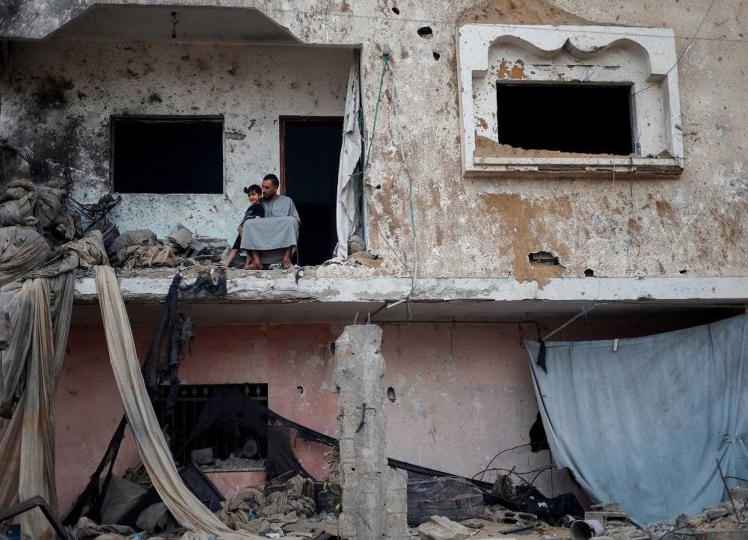 A Palestinian man is seen at his destroyed house after an Israeli raid on Gaza. (Reuters) 