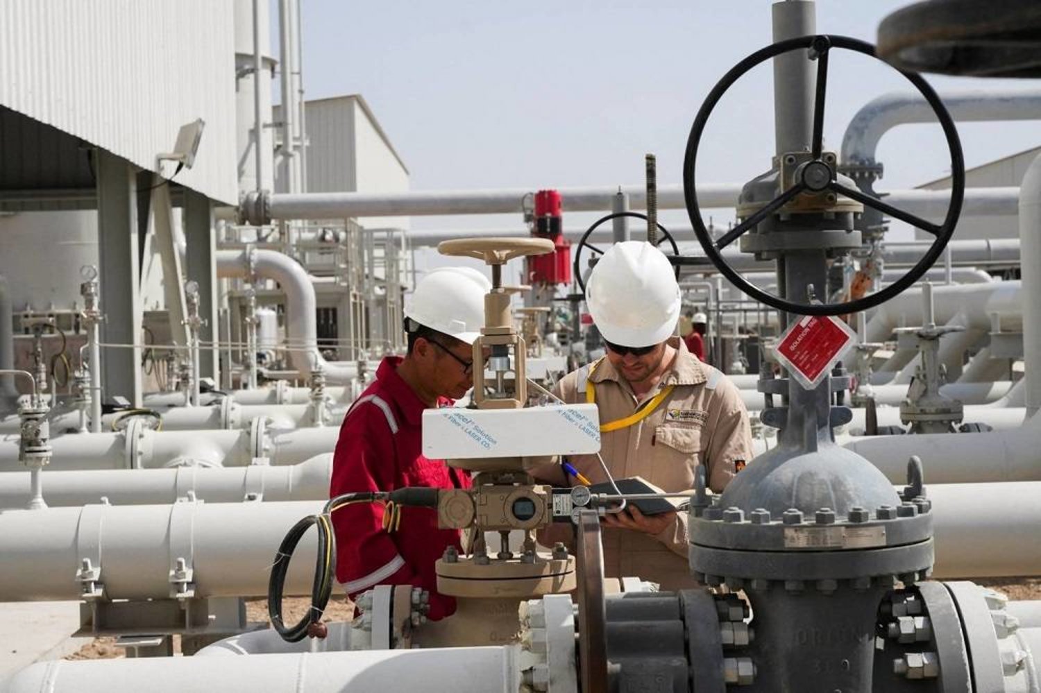 Technicians working at the Majnoon oil field in Basra, Iraq. (Reuters) 