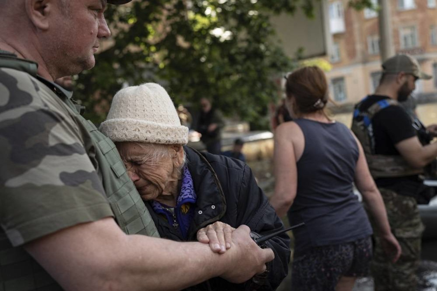 A woman cries as she is evacuated from a flooded neighborhood in Kherson, Ukraine, Wednesday, June 7, 2023 after the Kakhovka dam was blown up. (AP) 