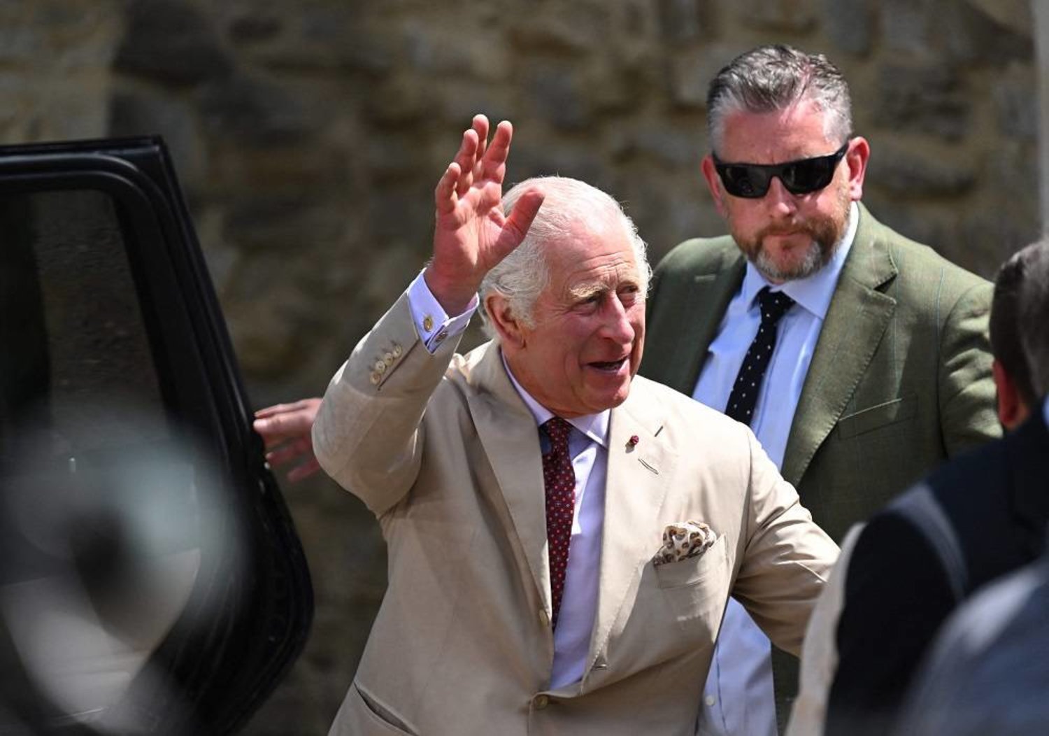 Britain's King Charles III salutes people as he exits the fortified evangelical church in in the village of Viscri, central Transylvania, Romania on June 6, 2023. (AFP) 