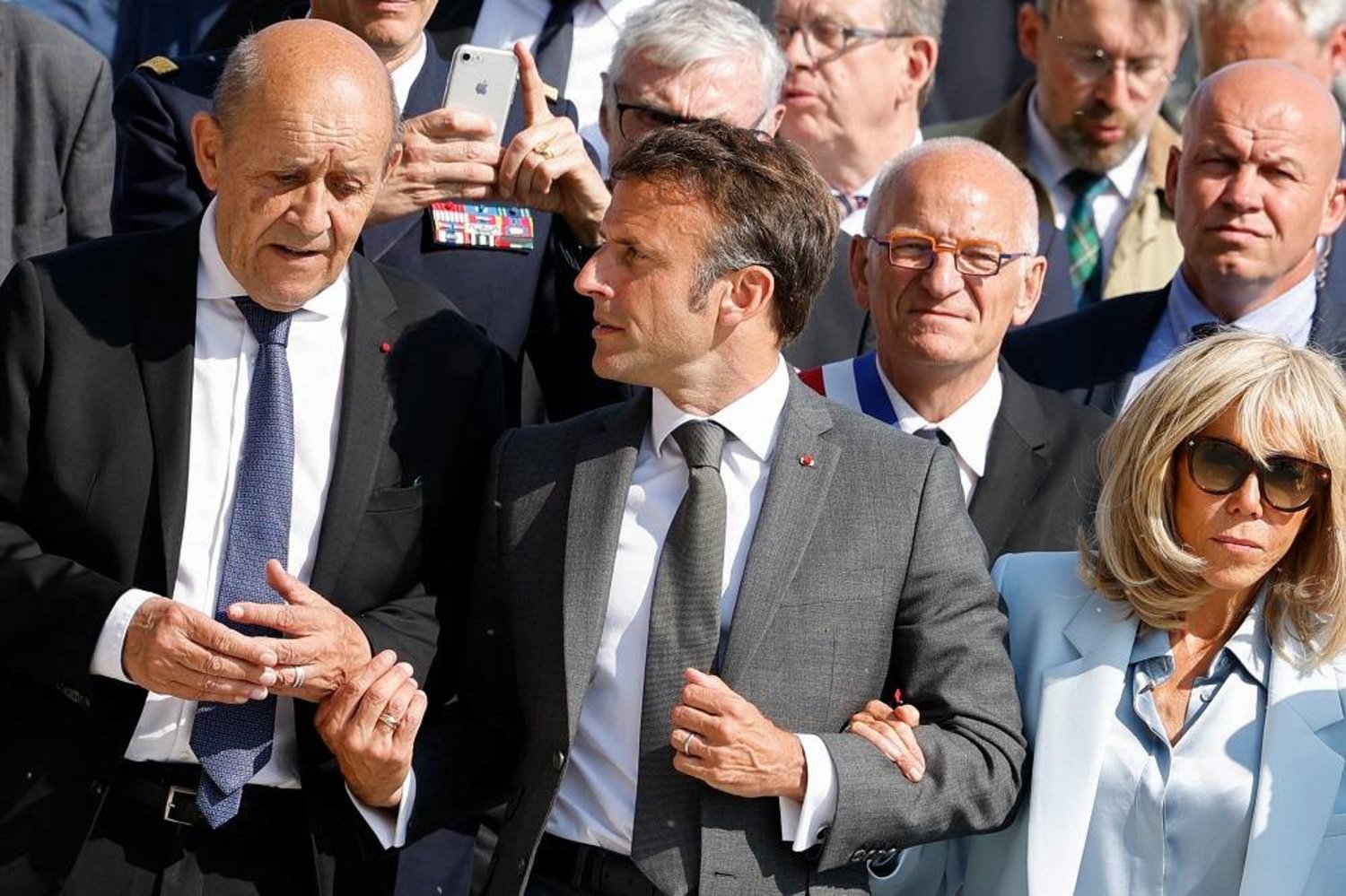 France's President Emmanuel Macron (C) arrives with his wife, Brigitte Macron (R) and his former Foreign Minister Jean-Yves Le Drian (L), for a two-day visit in Le Mont-Saint-Michel, north-western France, on June 5, 2023. (AFP) 