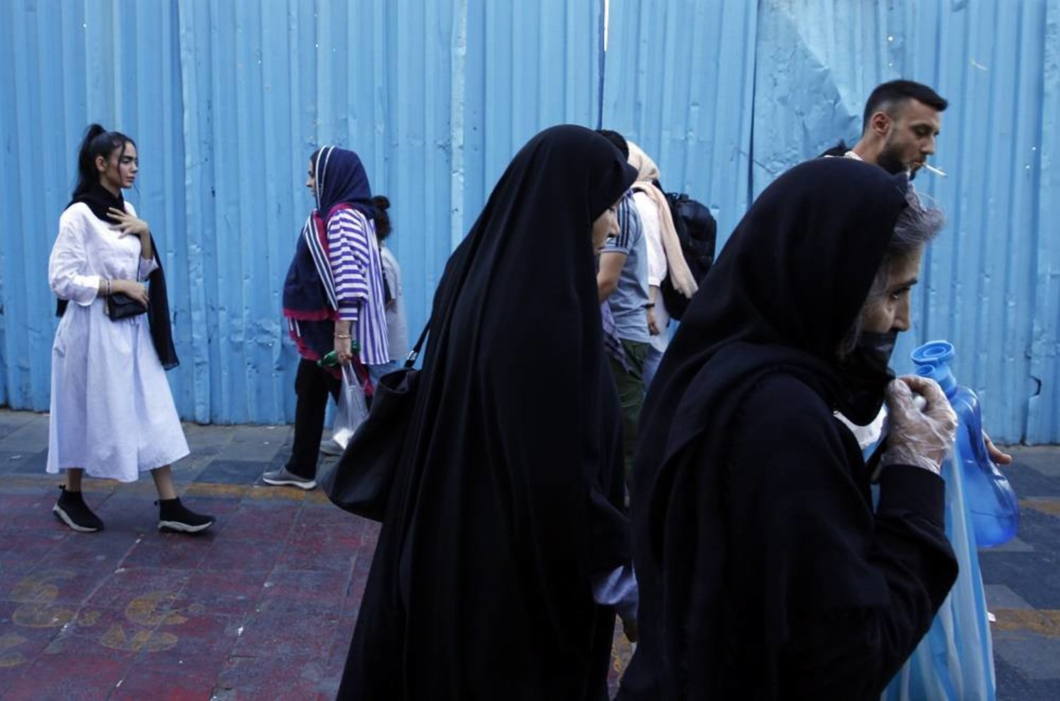 Iranian women, some without the mandatory headscarf, walk in a street in Tehran, Iran, 13 September 2023. (EPA)