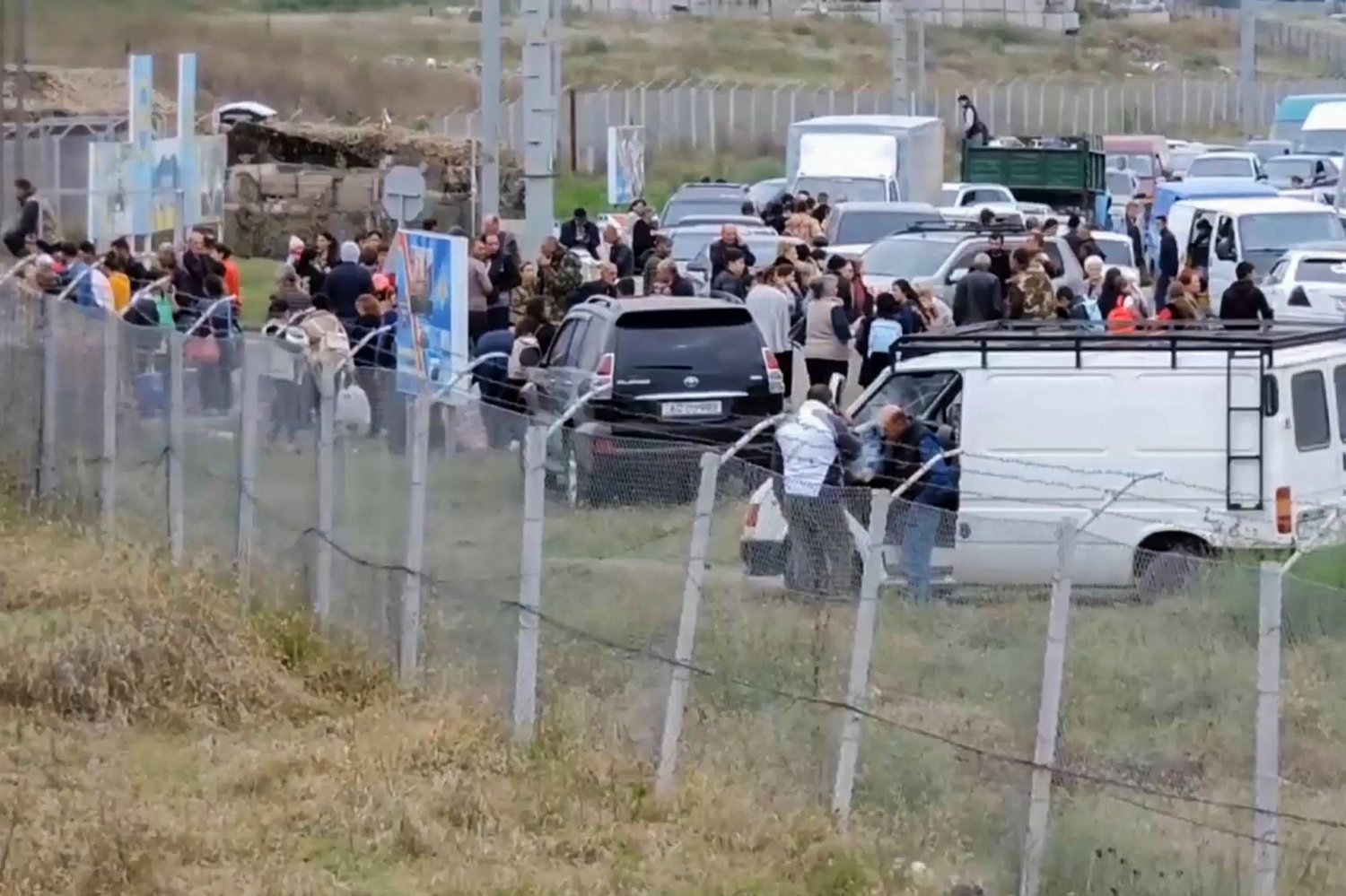 In this video grab taken from a handout footage and released by the Russian Defense Ministry on September 21, 2023, Armenian civilians arrive at Russian military base near Stepanakert in the Nagorno-Karabakh region. (Photo by Handout / Russian Defense Ministry / AFP) 
