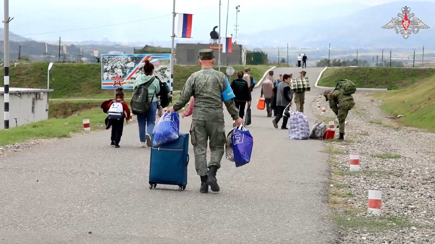 Russian peacekeepers evacuate civilians following Azerbaijani armed forces' offensive operation in Nagorno-Karabakh, a region inhabited by ethnic Armenians, in an unknown location, in this still image from video published September 21, 2023. Russian Defense Ministry/Handout via REUTERS 