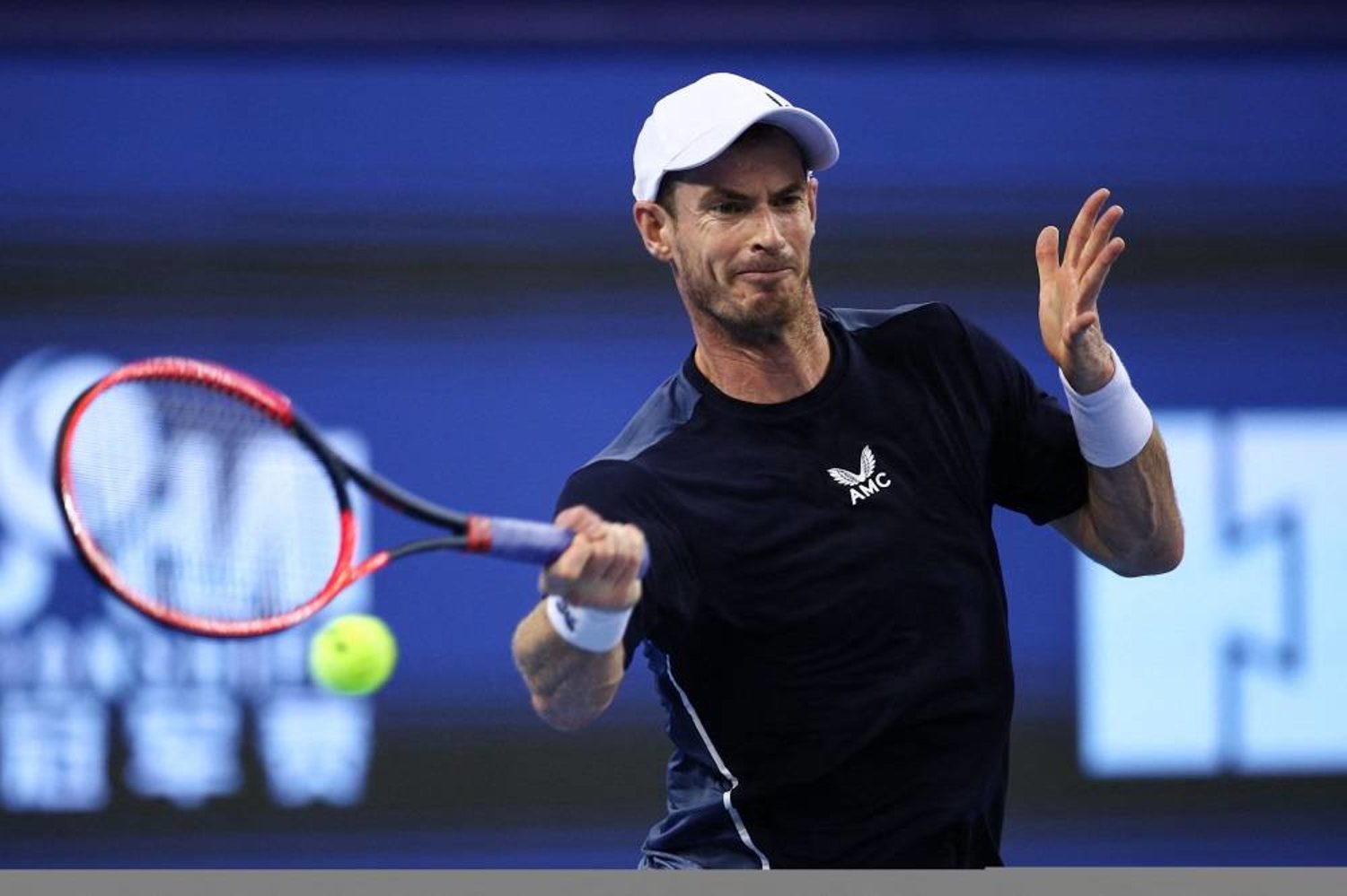 Andy Murray of Britain hits a return against Mo Yecong of China during their men's singles first round match at the Zhuhai Championships tennis tournament in Zhuhai, in China's southern Guangdong province on September 21, 2023. (AFP)