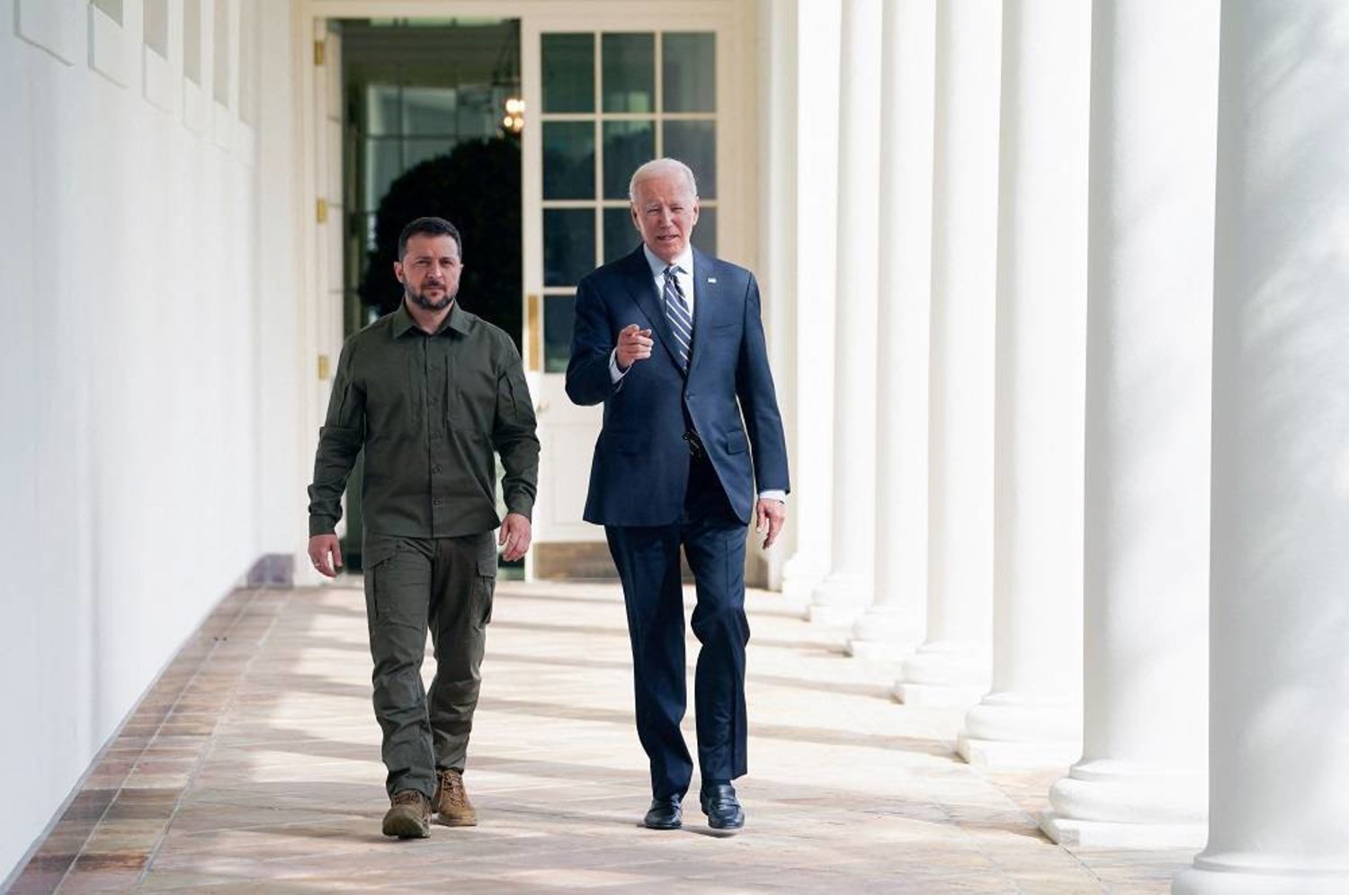 Ukrainian President Volodymyr Zelenskiy walks down the White House colonnade to the Oval Office with US President Joe Biden during a visit to the White House in Washington, DC, on September 21, 2023. (AFP) 