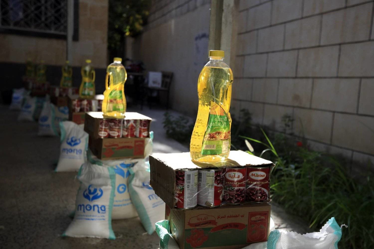 Food rations are being prepared in Sanaa to be distributed to distressed families. (EPA)