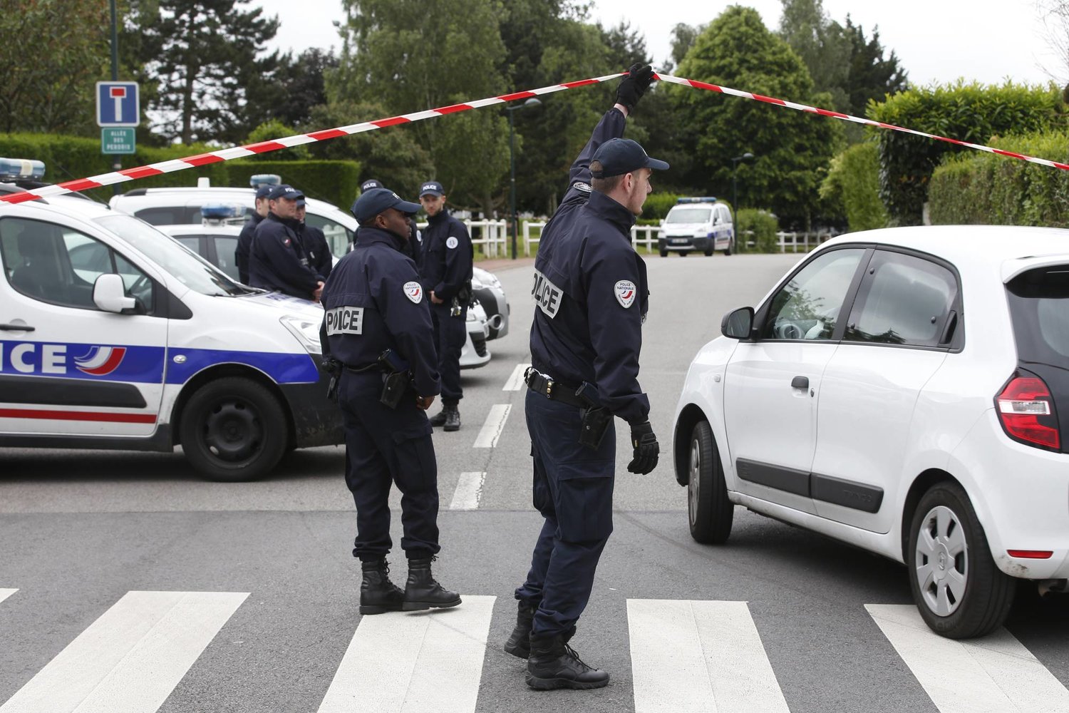 FILE - French police officers work at the crime scene the day the attacker killed the couple in Magnanville, west of Paris, France, on June 14, 2016. (AP Photo/Thibault Camus, File)