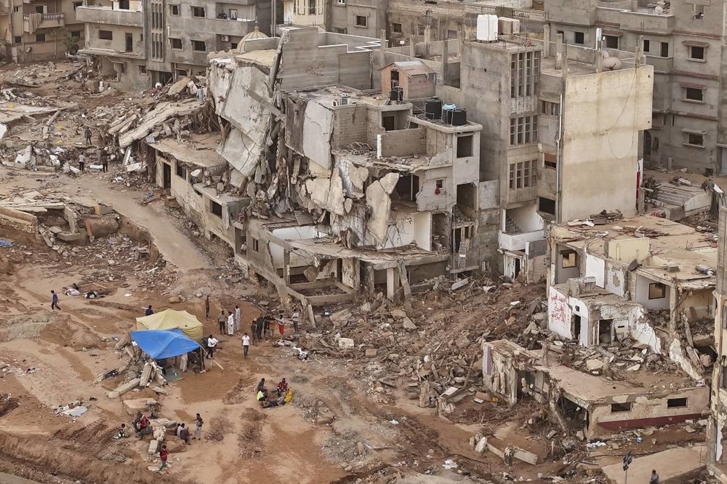 Rescuers and relatives of victims set up tents in front of collapsed buildings in Derna, Libya, on Sept. 18, 2023. (AP)