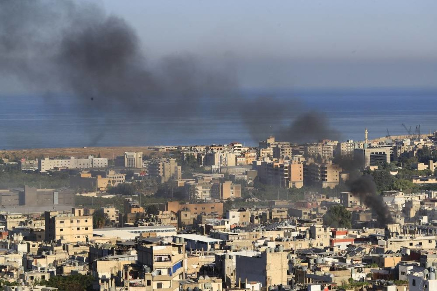 Smoke rises during clashes between members of the Palestinian Fatah group and Islamist militants in the Palestinian refugee camp of Ain el-Hilweh near the southern port city of Sidon, on Sept. 8, 2023. (AP) 