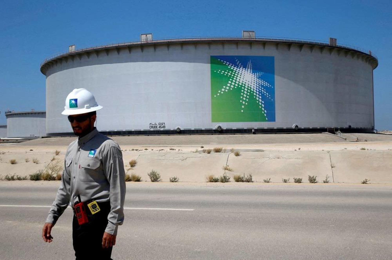 An Aramco employee walks near an oil tank at Saudi Aramco's Ras Tanura oil refinery and oil terminal in Saudi Arabia May 21, 2018. (Reuters)