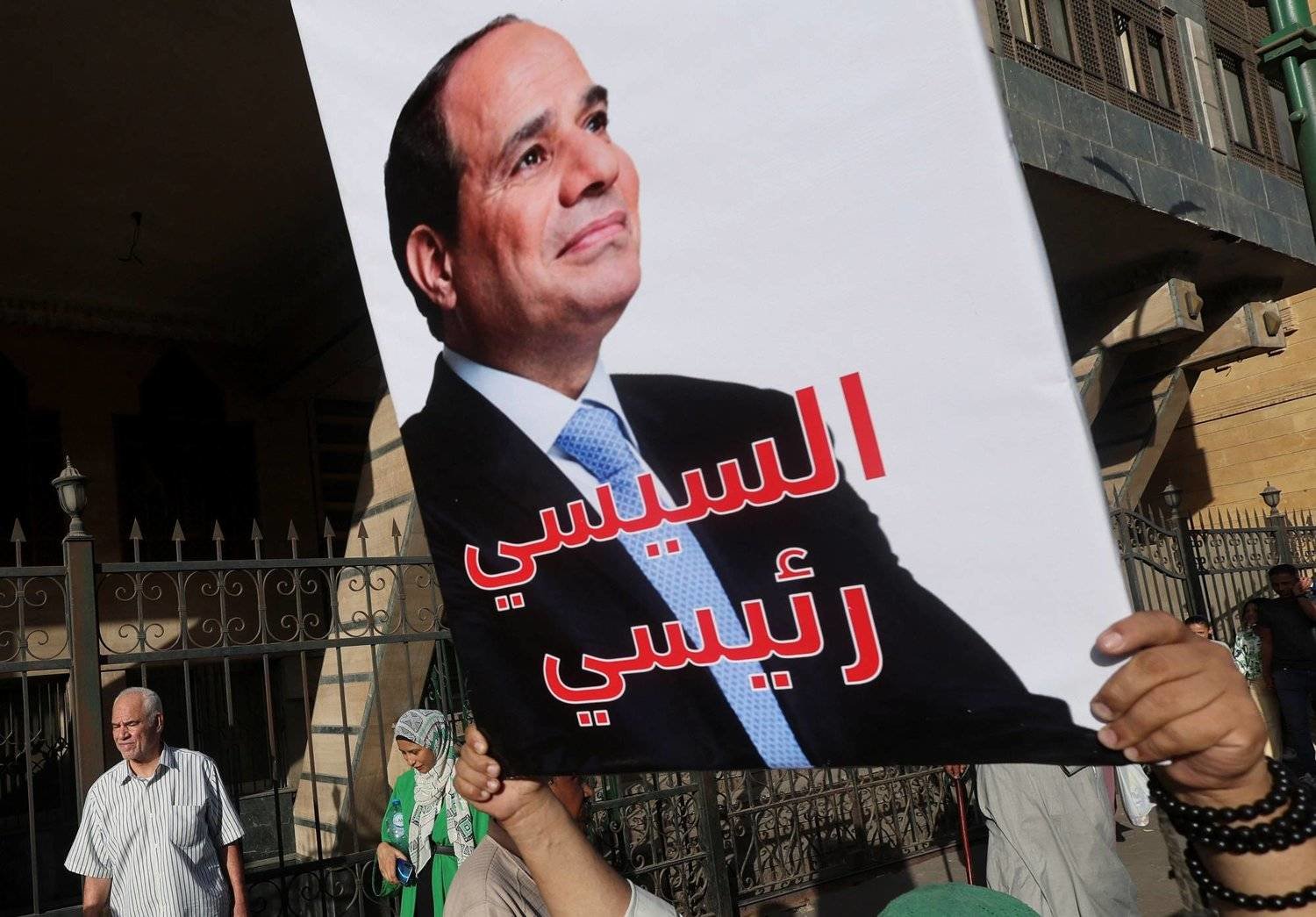 A supporter carries a pro-Sisi banner during Prophet’s Birthday celebration in Al-Azhar District, Cairo. (Reuters) 