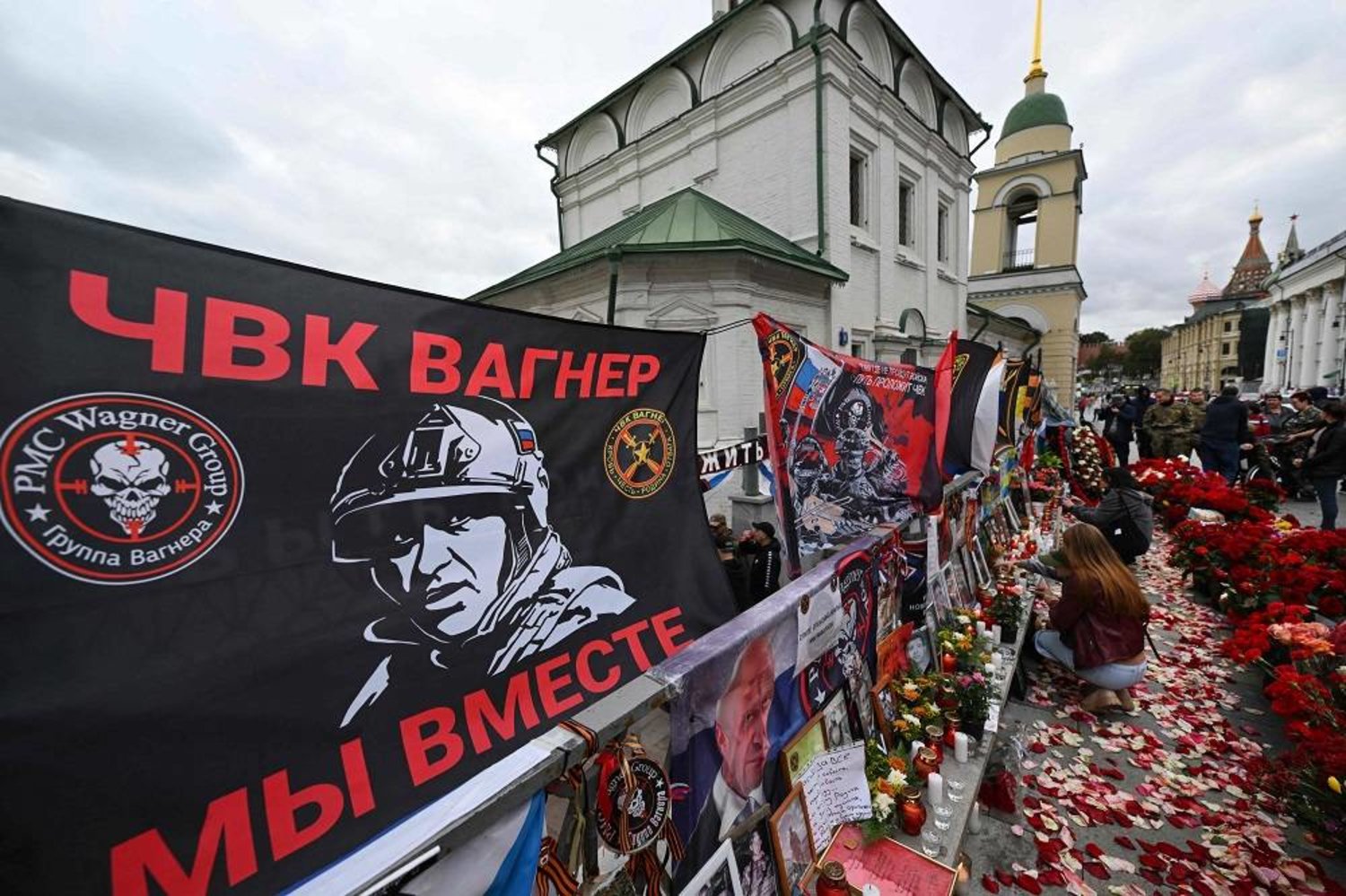 People visit a makeshift memorial for Wagner private mercenary group chief Yevgeny Prigozhin in central Moscow on October 1, 2023, to mark 40 days since his death as per Orthodox tradition. (AFP)