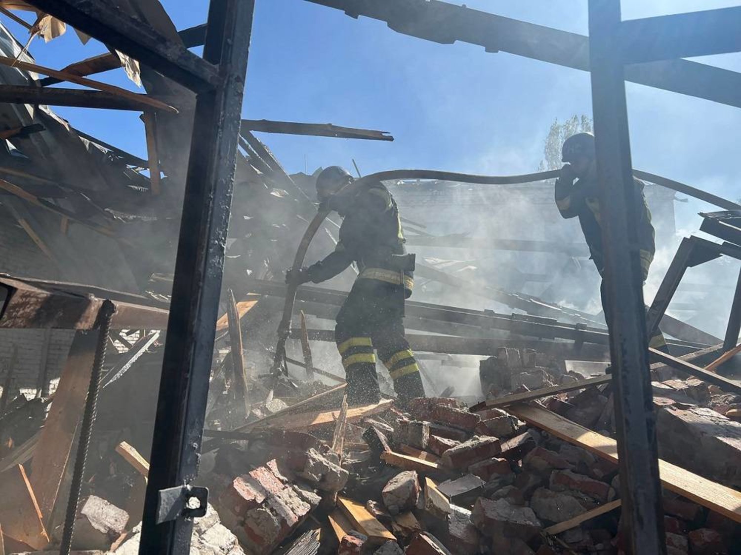 A handout photo released by the press service of the State Emergency Service (SES) of Ukraine shows firefighters working at a site of a missile strike in Kryvyi Rih, Dnipropetrovsk region, central Ukraine, 08 September 2023, amid the Russian invasion. (State Emergency Service of Ukraine/EPA) 