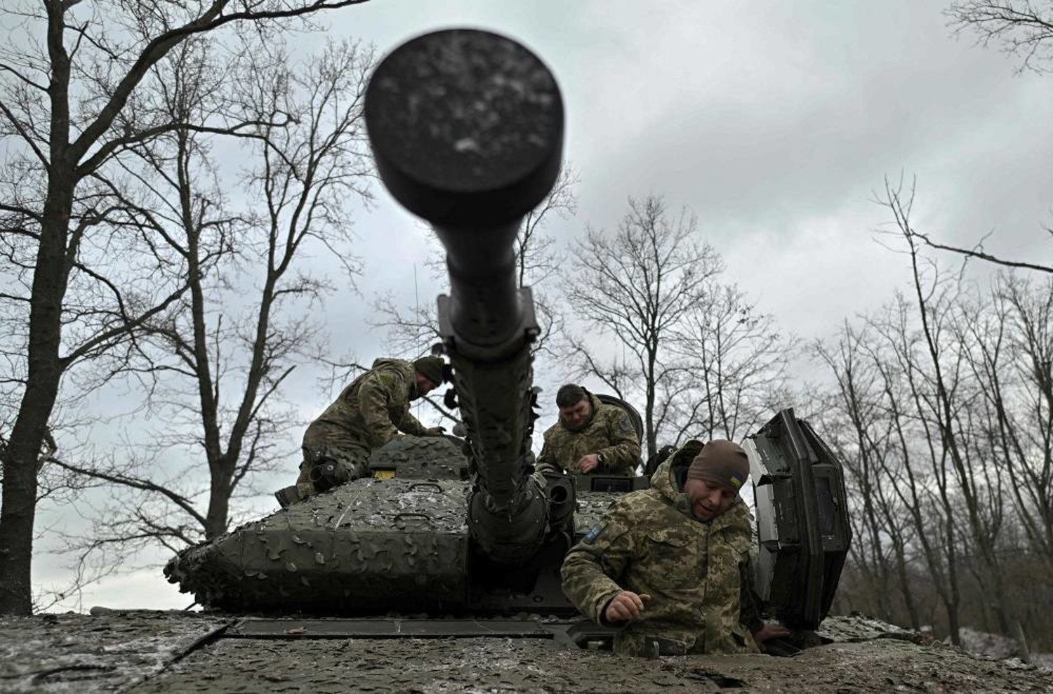 Ukrainian servicemen check their Sweden made CV90 armored infantry combat vehicle on a position pointing in the direction of Bakhmut in the Donetsk region on November 27, 2023, amid the Russian invasion of Ukraine. (AFP)