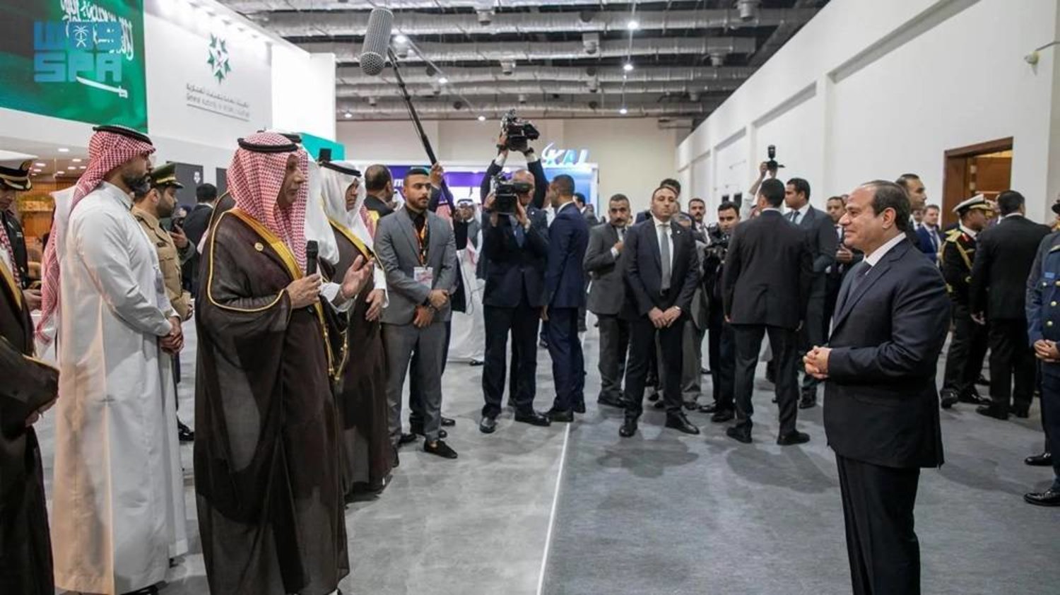 President SIsi is briefed on the products and offerings of national companies participating under the Saudi pavilion. (SPA)